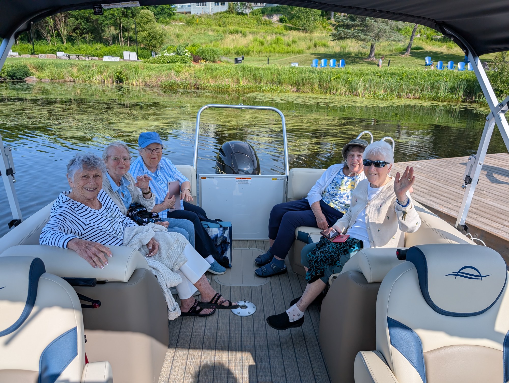 Five residents on a pontoon boat outing