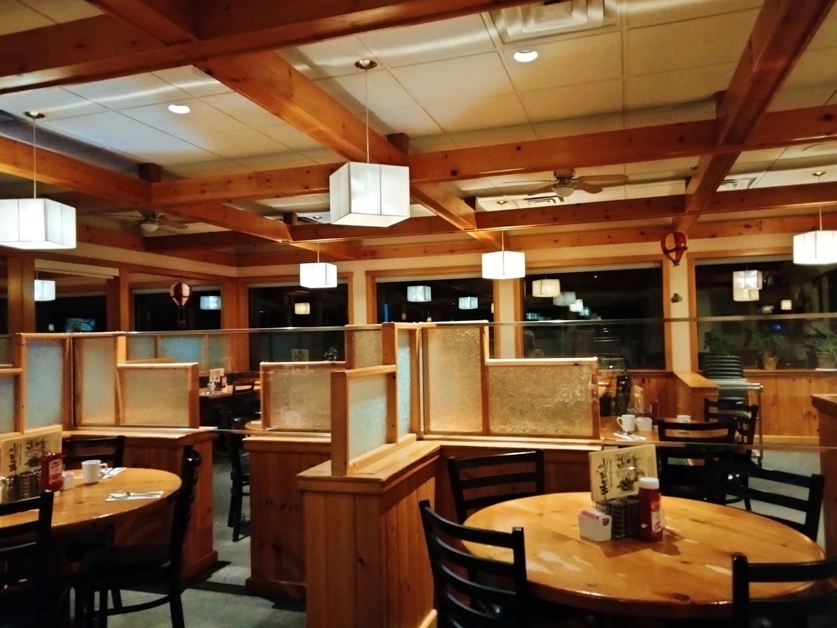 The dining room at Mom's Restaurant in Midland, with wood beams, round wooden tables and booths